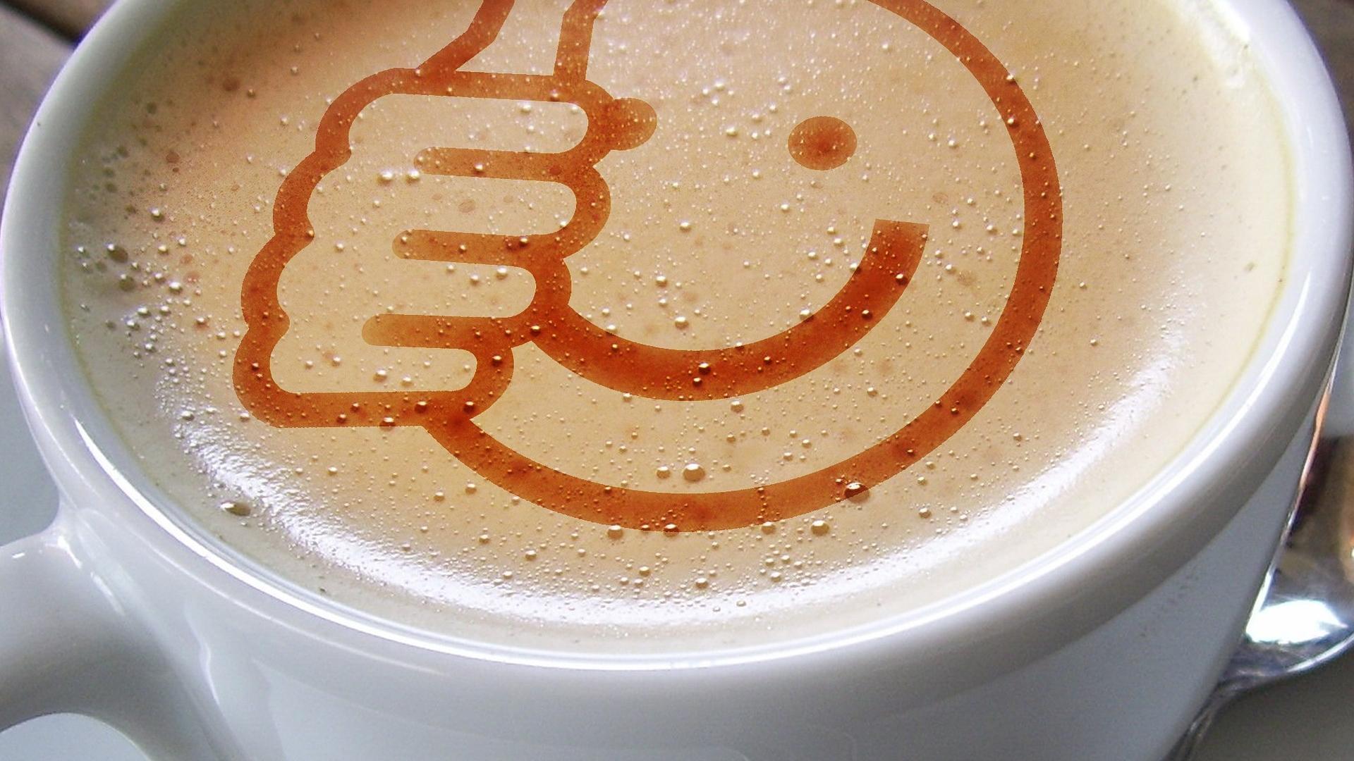 Kopje koffie met een positieve smiley in het schuim getoond